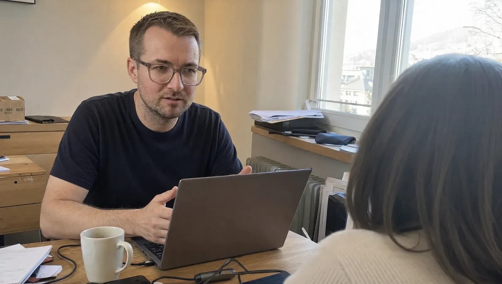 Marcus Martini bespricht mit einer Kundin am Laptop den Aufbau ihrer Website